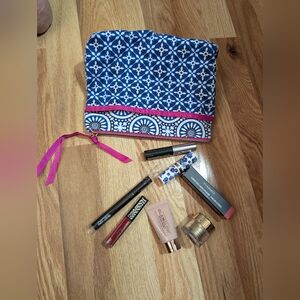 Blue and White Patterned Makeup Bag with Assorted Cosmetics